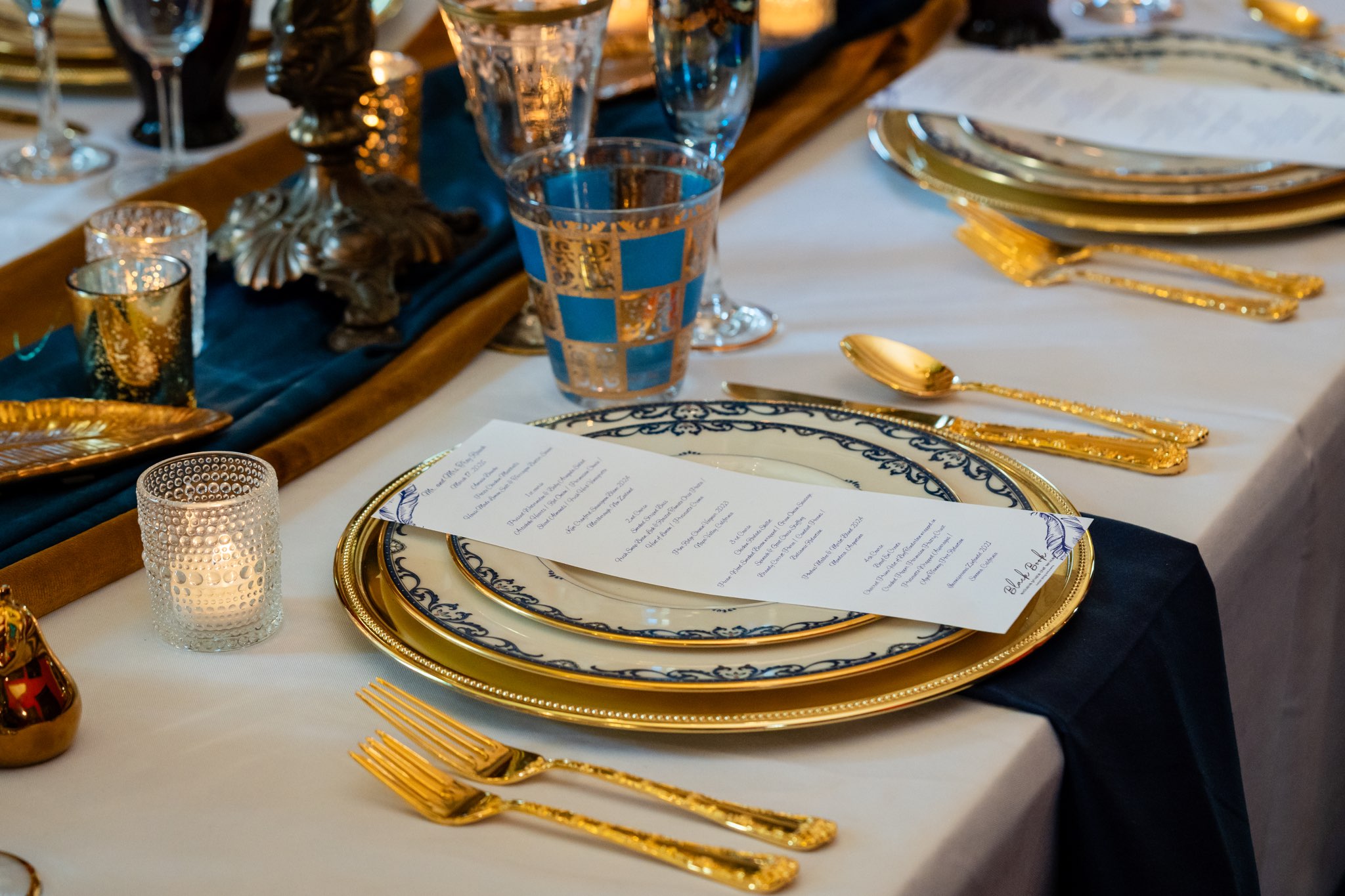 Elegant private celebration table setting with gold and blue accents at Canal Street Inn