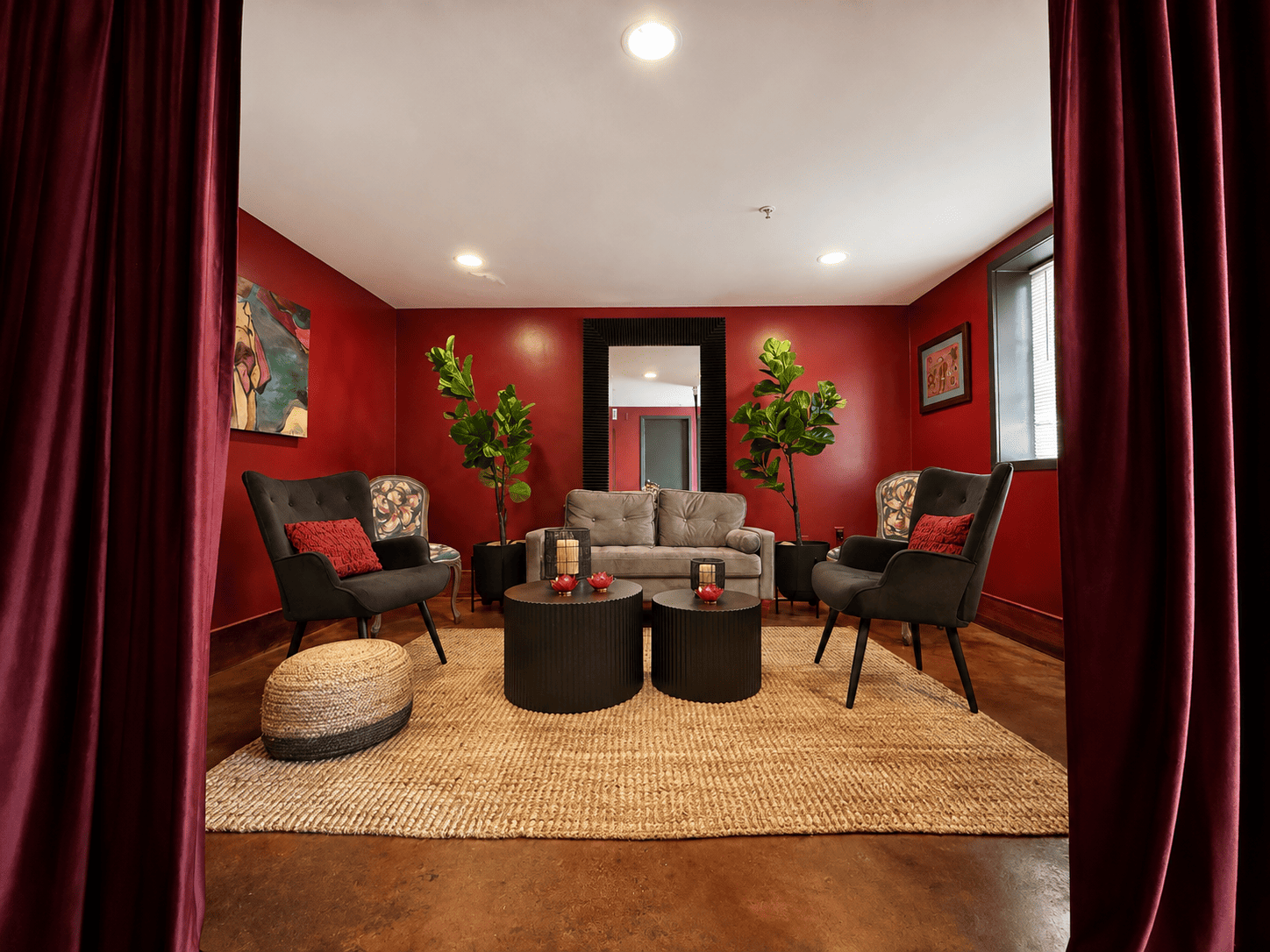 Canal Street Inn lounge with green velvet seating, patterned wallpaper and a carved mantel