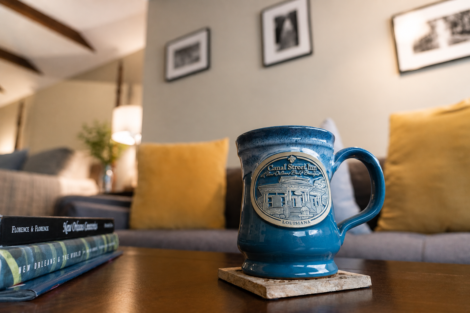 The Canal Street Room — Canal Street Inn mug on the coffee table with New Orleans books