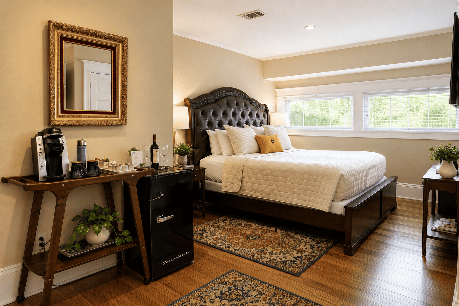 The Fleur-de-lis Room — king bed with tufted leather headboard, coffee station, and garden-facing windows