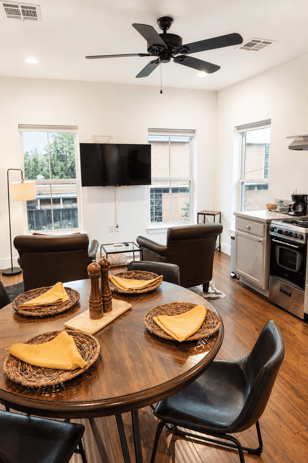 Second Floor Garden View Apartment — dining table, leather armchairs, and garden-facing windows