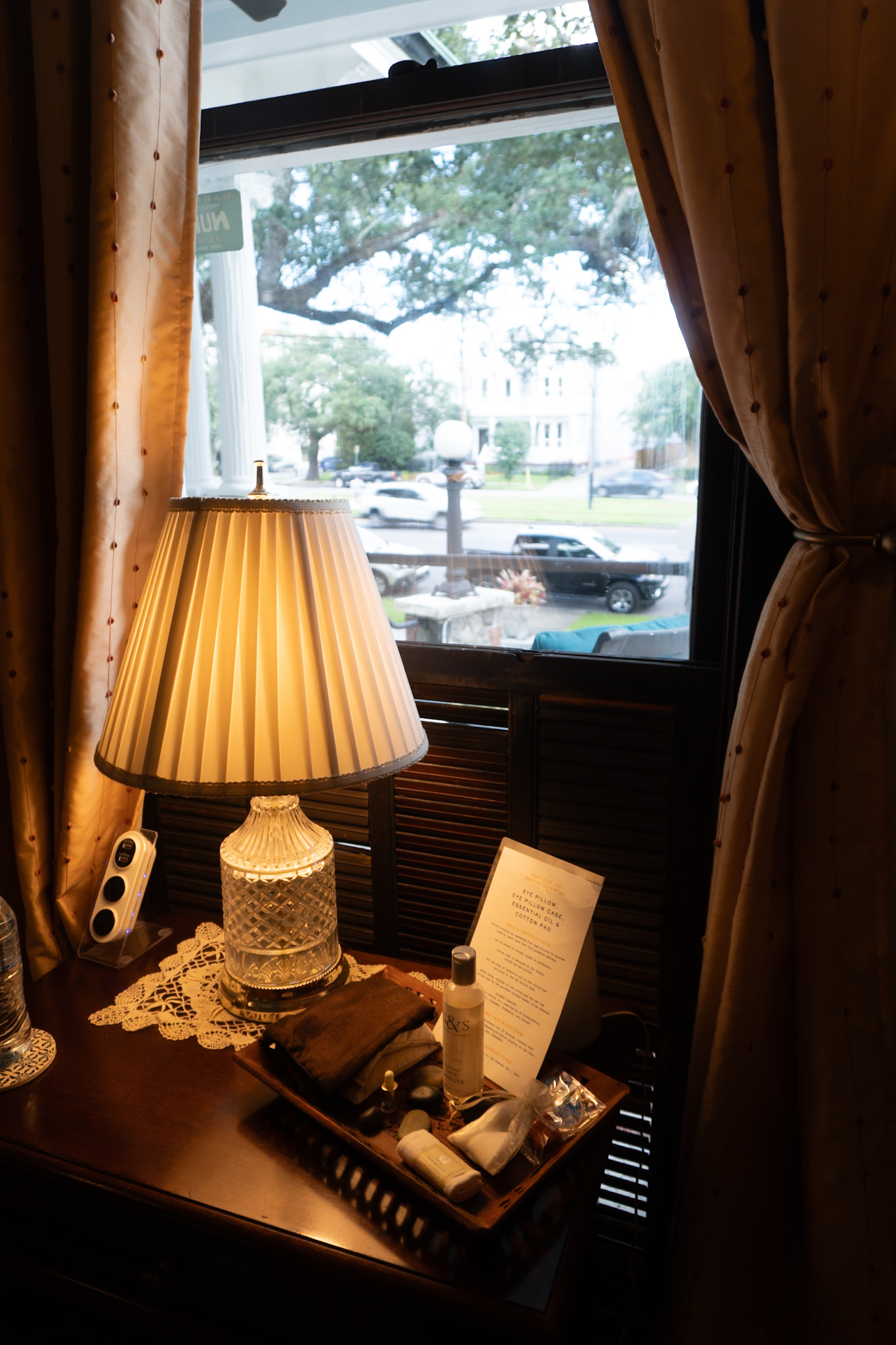 The Street Car Room — bedside lamp and window view of Canal Street